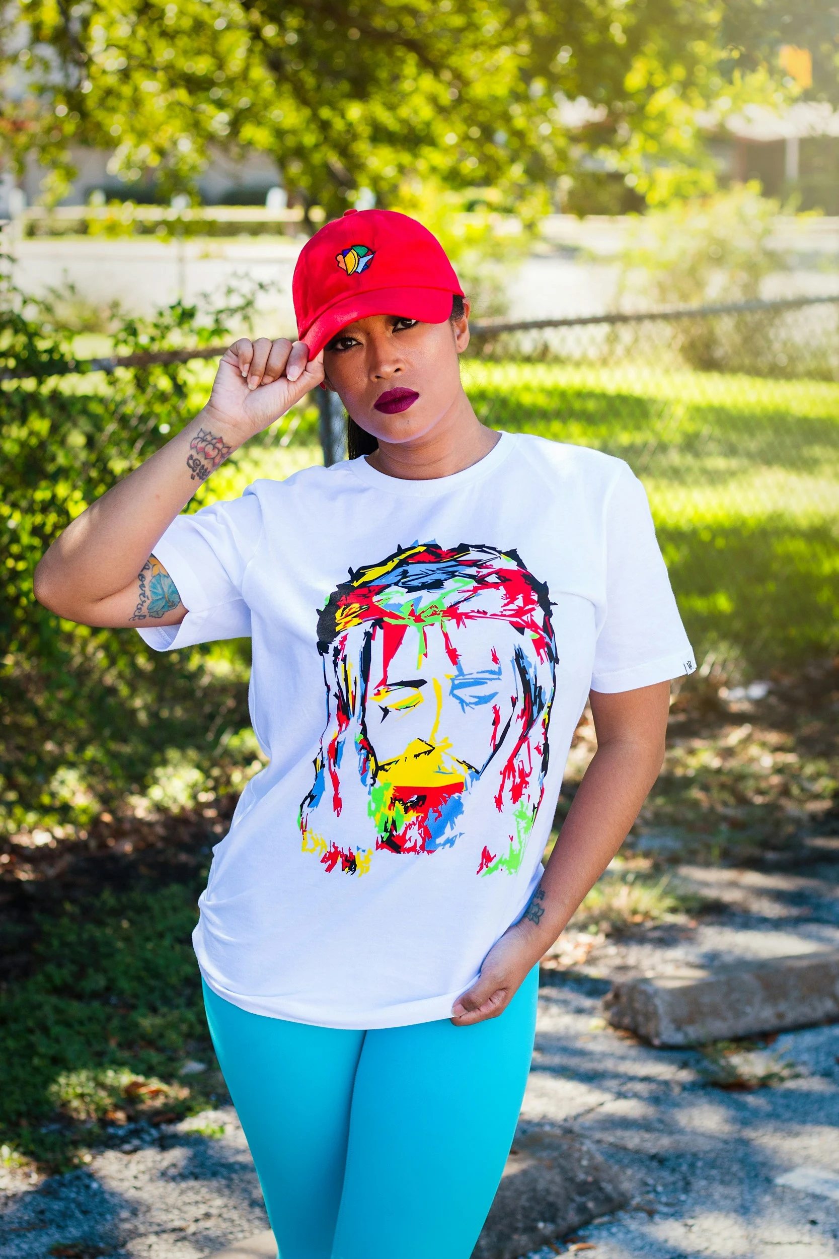 White t-shirt with colorful face print.